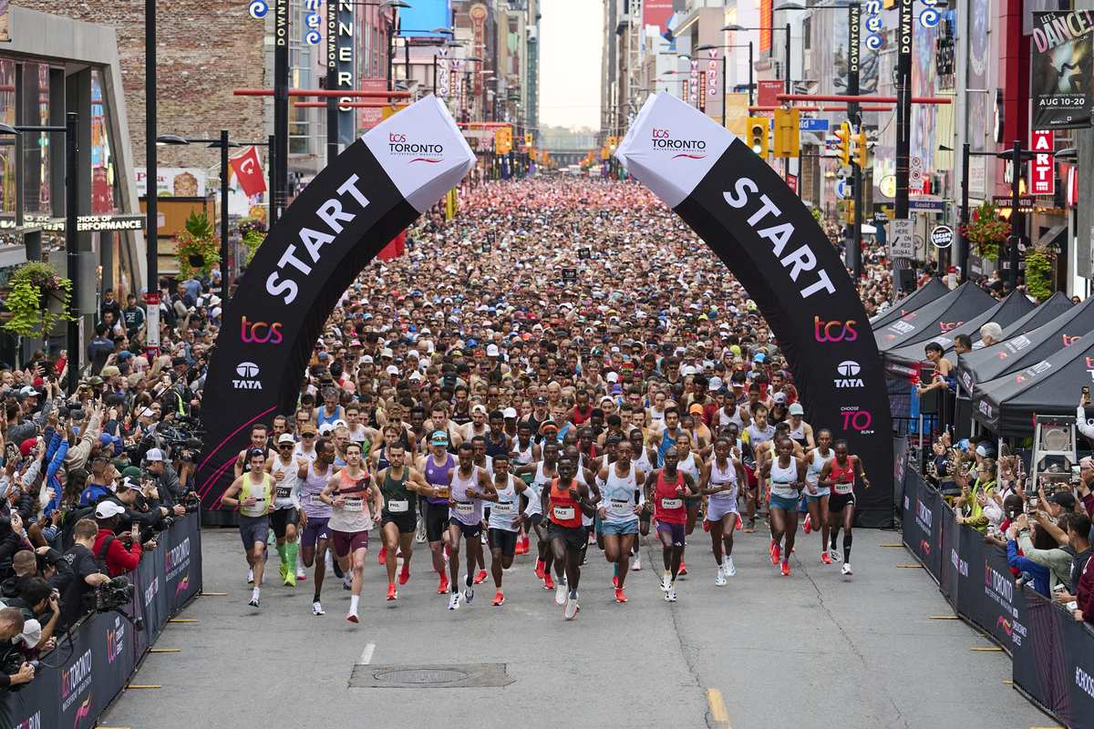 Thousands of runners at the start line of the TCS Toronto Waterfront Marathon on Yonge Street, October 18, 2026
